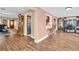 Open concept living room showcases hardwood floors, direct access to kitchen, and large windows to the sunroom at 2597 Bramblewood E Dr, Clearwater, FL 33763