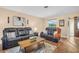 Cozy living room featuring neutral walls, wood-look floors, and comfortable seating, perfect for relaxation at 2597 Bramblewood E Dr, Clearwater, FL 33763