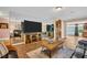 Bright and airy living room with ample seating, a large television, and stylish modern decor at 2597 Bramblewood E Dr, Clearwater, FL 33763