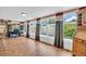 Spacious sunroom filled with natural light, featuring hardwood floors, and large windows showcasing the well-maintained backyard at 2597 Bramblewood E Dr, Clearwater, FL 33763