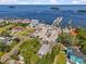 Panoramic aerial view displays real estate adjacent to a marina, with water and tropical foliage visible at 273 Shore Dr, Palm Harbor, FL 34683