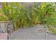 Backyard with brick patio, lush landscaping, and a cozy seating area at 273 Shore Dr, Palm Harbor, FL 34683