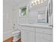 All-white bathroom with large vanity, tub, and shower, offering a clean, modern design at 273 Shore Dr, Palm Harbor, FL 34683