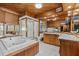 Large Primary bathroom featuring a soaking tub, a step-in shower, and wood paneled walls at 273 Shore Dr, Palm Harbor, FL 34683