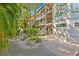 Exterior view of a multi-level home with lush tropical landscaping and stone walkways at 273 Shore, Palm Harbor, FL 34683