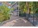 Charming multi-story home featuring balconies, a brick driveway, and lush tropical landscaping at 273 Shore Dr, Palm Harbor, FL 34683