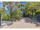 Stunning home with multi-level balconies surrounded by lush tropical plants offers stylish coastal living at 273 Shore Dr, Palm Harbor, FL 34683