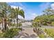 Exterior view features lush landscaping and partial view of a waterfront at 273 Shore Dr, Palm Harbor, FL 34683