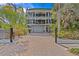 A grand three-story waterfront home featuring a private driveway, a multi-car garage and multiple balconies at 273 Shore, Palm Harbor, FL 34683