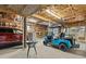 The large garage includes a red SUV and a teal golf cart, offering ample space and convenience at 273 Shore Dr, Palm Harbor, FL 34683