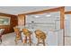 Eat-in kitchen featuring a breakfast bar and new white cabinets and stainless steel appliances at 273 Shore Dr, Palm Harbor, FL 34683