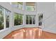 Bright living room with large windows offering views of the lush greenery outside at 273 Shore Dr, Palm Harbor, FL 34683