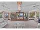 Open living room with views of the ocean and a wall of windows to the balcony at 273 Shore Dr, Palm Harbor, FL 34683