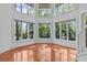 Bright living room with many windows offering expansive views of the surrounding trees at 273 Shore Dr, Palm Harbor, FL 34683