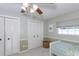 Shared bedroom with storage cabinets, wall art and overhead fan at 2831 Quail Hollow W Rd, Clearwater, FL 33761