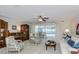 Open-concept living room featuring neutral carpet, stylish accents, and pool views at 2831 Quail Hollow W Rd, Clearwater, FL 33761