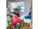 Inviting living room with bright furniture, decorative floral arrangement and outdoor pool area at 2831 Quail Hollow W Rd, Clearwater, FL 33761