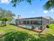 Expansive backyard featuring a screened-in pool area and lush green landscaping at 2850 Allapattah Dr, Clearwater, FL 33761