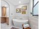 Stylish bathroom featuring a freestanding tub, tiled walls, and elegant decor with natural light at 2850 Allapattah Dr, Clearwater, FL 33761