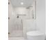 Contemporary bathroom with a glass-enclosed shower, complemented by sleek fixtures and neutral tones at 2850 Allapattah Dr, Clearwater, FL 33761