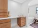 Bright bathroom with a built-in vanity and storage, complemented by a modern soaking tub at 2850 Allapattah Dr, Clearwater, FL 33761