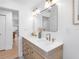 Bright bathroom features double sinks, contemporary fixtures, and hardwood flooring at 2850 Allapattah Dr, Clearwater, FL 33761