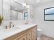 Bathroom boasts double sinks, modern fixtures, decorative mirror, and natural lighting at 2850 Allapattah Dr, Clearwater, FL 33761