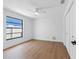 Cozy bedroom with hardwood floors, a black framed window and a spacious closet at 2850 Allapattah Dr, Clearwater, FL 33761
