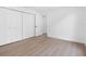 Bright bedroom with hardwood floors and a closet with modern black hardware at 2850 Allapattah Dr, Clearwater, FL 33761