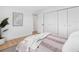 Bright bedroom with closet, neutral color palette, and hardwood floors at 2850 Allapattah Dr, Clearwater, FL 33761