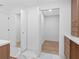 Bathroom featuring multiple closets and updated vanity with marble countertop at 2850 Allapattah Dr, Clearwater, FL 33761