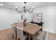 Elegant dining room with wood table, chandelier, and contemporary decor at 2850 Allapattah Dr, Clearwater, FL 33761