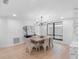 Well-lit dining room featuring modern decor, natural light, and stylish chandelier over a wooden table at 2850 Allapattah Dr, Clearwater, FL 33761
