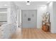 Bright foyer with updated flooring, stone accent wall, and white paint throughout at 2850 Allapattah Dr, Clearwater, FL 33761