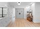 Bright foyer with a stone accent wall, light hardwood floors, and a stylish console table with decorative elements at 2850 Allapattah Dr, Clearwater, FL 33761