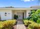 Inviting entryway with double doors, modern lighting, and lush landscaping leading to the entrance of the home at 2850 Allapattah Dr, Clearwater, FL 33761