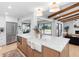 An open-concept kitchen features a large island, stainless steel appliances, and pool views at 2850 Allapattah Dr, Clearwater, FL 33761