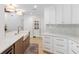 Well-lit kitchen features ample counter space, white cabinets, and a farmhouse sink at 2850 Allapattah Dr, Clearwater, FL 33761