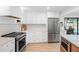 Modern kitchen featuring stainless steel appliances, marble countertops, and a pool view at 2850 Allapattah Dr, Clearwater, FL 33761
