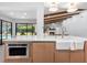 Spacious kitchen island with a built-in microwave, farmhouse sink, and ample cabinet space at 2850 Allapattah Dr, Clearwater, FL 33761