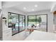 Sunlit breakfast nook off the kitchen with pool views through expansive sliding glass doors at 2850 Allapattah Dr, Clearwater, FL 33761