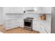 Modern kitchen features white cabinets, marble countertops, and a stainless steel KitchenAid oven at 2850 Allapattah Dr, Clearwater, FL 33761
