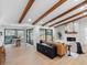 Stylish living area with wood beam ceilings, a fireplace, and a view of the pool at 2850 Allapattah Dr, Clearwater, FL 33761