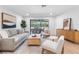 Bright living room with stylish furniture, wood floors, and seamless access to the outdoor patio at 2850 Allapattah Dr, Clearwater, FL 33761