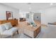 Open living room with wood floors, comfortable seating, and a view into the dining area at 2850 Allapattah Dr, Clearwater, FL 33761