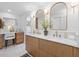 Modern main bathroom featuring a double vanity with gold accents, stylish mirrors and white marble flooring at 2850 Allapattah Dr, Clearwater, FL 33761