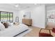 Bright main bedroom featuring new flooring, white walls, and backyard views at 2850 Allapattah Dr, Clearwater, FL 33761