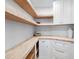 Walk-in pantry with wooden shelving and white cabinetry at 2850 Allapattah Dr, Clearwater, FL 33761