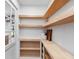 Walk-in pantry with wooden shelving and white cabinetry at 2850 Allapattah Dr, Clearwater, FL 33761