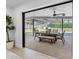 View of the outdoor dining area and pool from inside the home, through sliding glass doors at 2850 Allapattah Dr, Clearwater, FL 33761